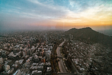 Fototapeta premium sunrise over the mountains and the skyline of santiago de chile