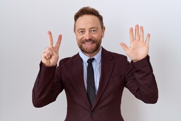 Middle age business man with beard wearing suit and tie showing and pointing up with fingers number seven while smiling confident and happy.