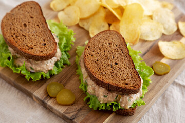 Homemade Tuna Sandwich with Lettuce on a wooden board, side view. Close-up.
