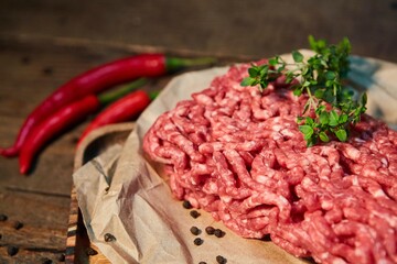 Raw meat in the form of minced meat on a paper surface. Raw food for cooking.