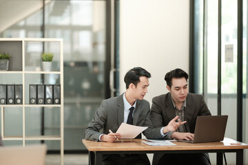 Group of business man discussion and brainstorming, bookkeeping audit graph and chart documents at desk, teamwork concept.