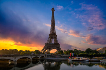 Naklejka na ściany i meble View of Eiffel Tower and river Seine at sunrise in Paris, France. Eiffel Tower is one of the most iconic landmarks of Paris