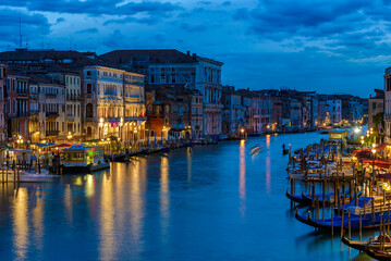 Obraz premium Grand Canal with gondolas in Venice, Italy. Night view of Venice Grand Canal. Architecture and landmarks of Venice. Venice postcard