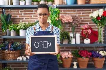 African american woman working at florist holding open sign depressed and worry for distress, crying angry and afraid. sad expression.