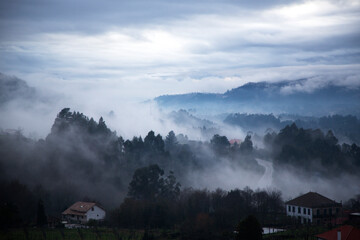 Fototapeta na wymiar Dawn between mountain ranges and fog.