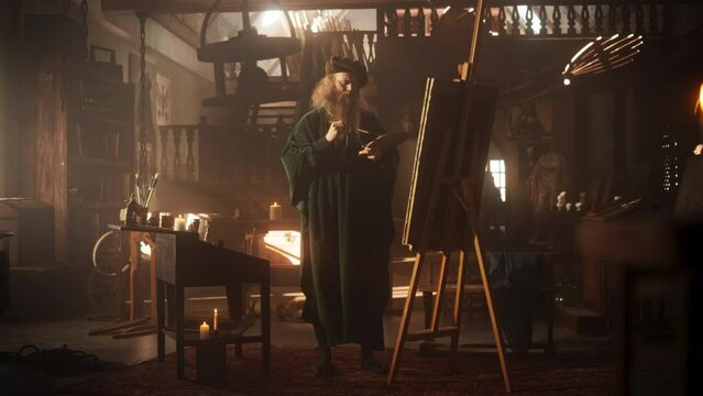 Wide Shot of Old Male Renaissance Artist Painting on Canvas in his Antique Workshop. Talented Historical Figure Working on his Next Masterpiece and Feeling Inspired While Transfering Ideas on Canvas