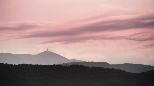 Time lapse. Sunset clouds moving over mountain landscape with Mont Ventoux in the distance, view from Baronnies Provencales Natural Park in France.