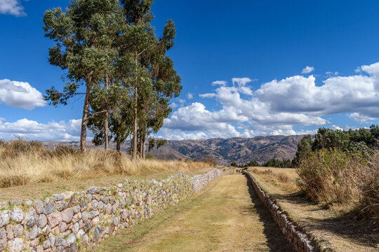 The landscape of the Urubamba province, view over the mountains, and a sunken path with stone walls, an example of the Inca building style.