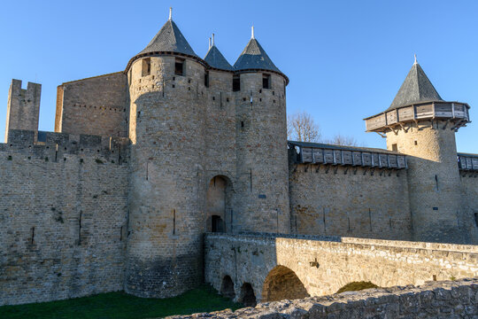 The Ch&acirc;teau Comtal, Count&rsquo;s Castle, is a medieval castle in the Cit&eacute; of Carcassonne, tall towers and wall, and a bridge to a fortified gate.