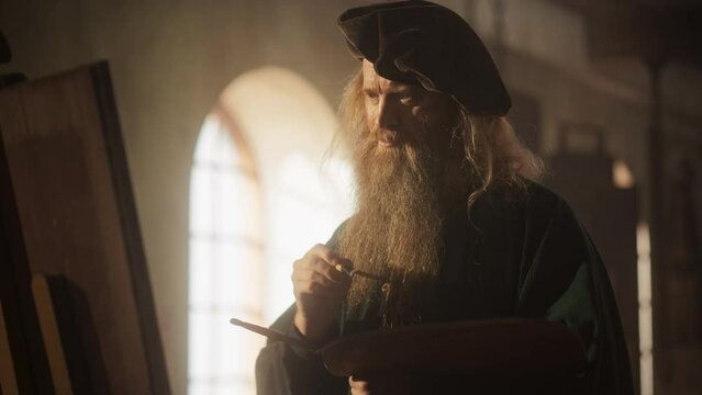 Medium Portrait of a Male Historical Figure Painting on Canvas in his Workshop. Famous Painter of the Renaissance Era Getting Inspired and Adding Details to his Masterpiece. Brilliant Minds in History