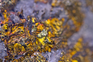 Golden background. Gold. Ore close-up. Nugget. Nugget close-up background. Crystals.