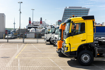 Side view many new heavy commercial cargo transport vehicles stand at port for export import...