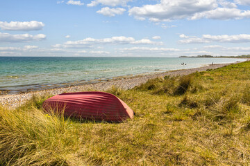 Red row boat at Baltic Sea coast, Danish island of Als