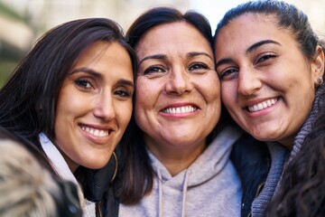 Three woman mother and daughters standing together at street
