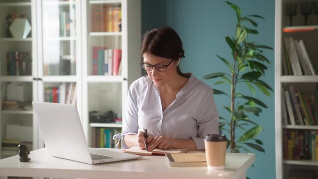 Frustrated middle aged woman studying online at home. Concept education for people aged.
Sad female 50s  worried nervous during online meeting while solving work issues, reporting to department head