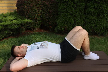 Man does lower back exercise Pelvic tilt