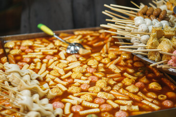 Local street food market with bamboo skewers or on a stick for snacking. Fishballs, Squid balls, Odeng