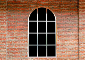 Fototapeta na wymiar Curve window with black glass on brick wall