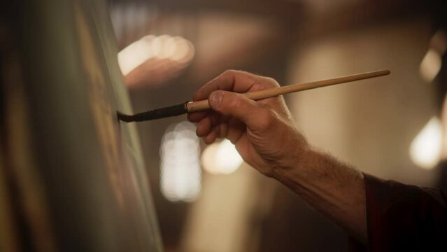 Close Up on Male Painter Hand Painting the Mona Lisa with Gentle Brush Movement. Details of the Famous Painting Being Drawn by its Creator. Pure Talent and Mastery of High Art, Everlasting Beauty