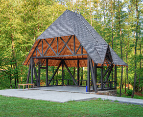 Wooden gazebo in the park. Wooden gazebo pergola, wooden summer house.