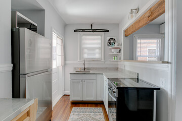 Cute Modern Small White Kitchen Interior in Historic Home with Exposed Wood Beam 