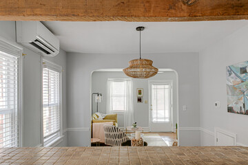 Rattan Pendant Light in Beautiful Dining Room with Wood Beams View and Curved Arched Walls