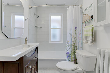 Fototapeta na wymiar Beautiful Chic Residential Traditional Modern Farmhouse White Bathroom Interior with tub shower backsplash wooden sink vanity