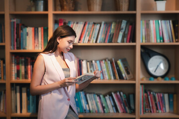 Young woman reading book. Young female student reading book at book store.