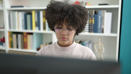 Young african american woman student using computer studying at university classroom