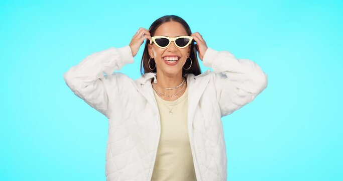 Fashion, sunglasses and portrait of woman with style or modern clothing isolated in a studio blue background. Aesthetic, gen z and young female person laughing and happy for trendy designer brand
