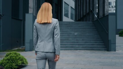 Back view unrecognizable caucasian woman business lady businesswoman manager employer leader ceo boss female professional worker walking outdoors near office building climbing stairs walk up steps