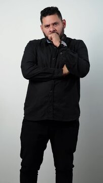 Man on white background in black shirt with Anger, Rage, Fury, Wrath, Resentment, Outrage, Indignation, Frustration, Irritation, Vexation, Enrage, Infuriate, Annoyance, Displeasure, Bitterness