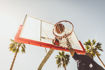 Basketball slam dunk on a californian court © oneinchpunch