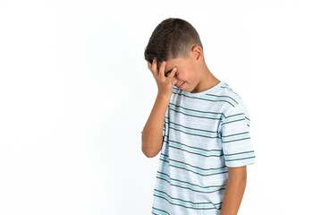 A very upset and lonely Little hispanic boy wearing  striped T-shirt  crying,