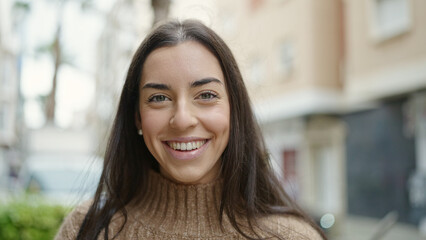 Young beautiful hispanic woman smiling confident standing at street