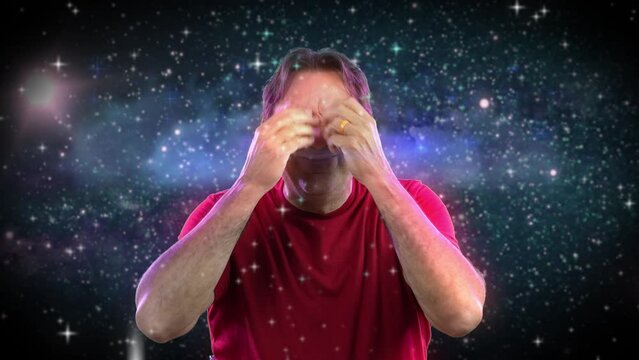 A man gives two mind blown meme gestures. Space background.  	