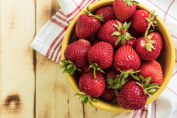 Fresh strawberries on a wooden table, close-up. View from the mountain