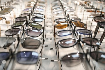 Sunglasses on display shelves in glasses store