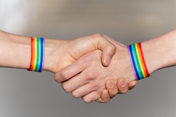 Close-up of a handshake with wristbands supporting the lgtbi movement. lgtbiq concept