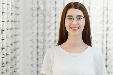 Young Woman with Eyeglasses in Optical Store - Beautiful girl wearing glasses in optician shop