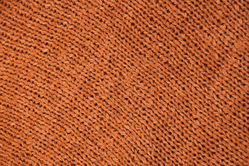 Fototapeta premium orange unusual texture.knitted brown sweater close up. handmade concept 