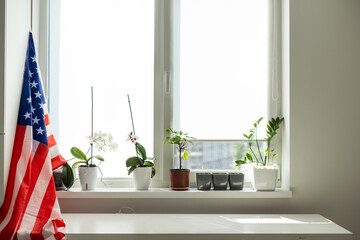 Interior of stylish room with modern workplace and USA flag