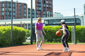 Mother and daughter playing basketball