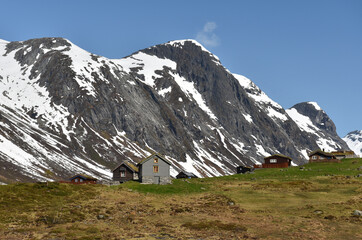 Fototapeta na wymiar Norwegische Häuser im schneebedecktem Gebirge 