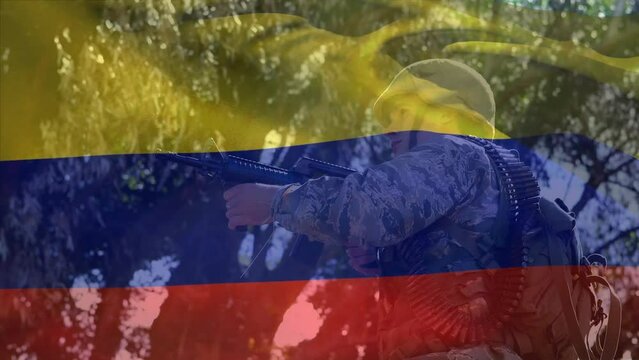 Animation of flag of colombia waving over low angle view of caucasian soldier standing with gun