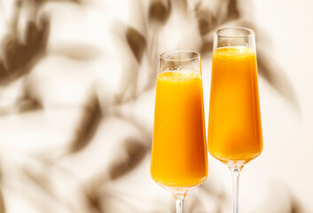 Mimosa summer cocktail drink with orange juice and cold dry champagne or sparkling wine in glasses....