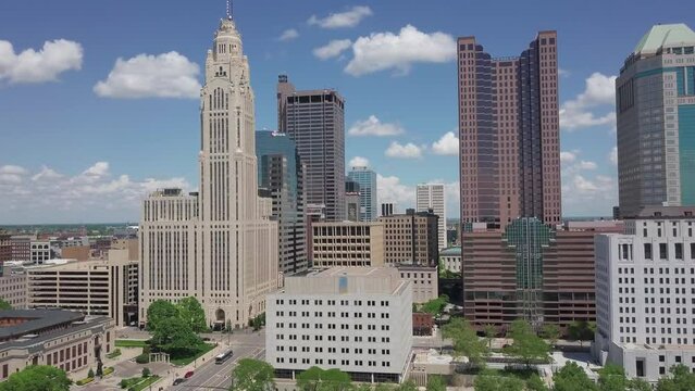 Drone moving aerial above LeVeque Tower and hotel in downtown district and capital city of Ohio in Columbus, OH