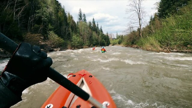 Kayaking on a wild river in the mountains POV