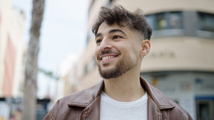 Young arab man smiling confident standing at street