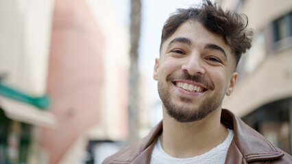 Young arab man smiling confident standing at street